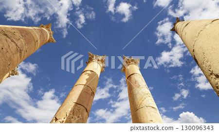 Roman Columns in the Jordanian city of Jerash (Gerasa of Antiquity), capital and largest city of Jerash Governorate, Jordan. Against the background of a beautiful sky with clouds 130096343