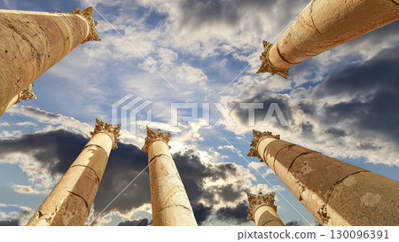 Roman Columns in the Jordanian city of Jerash (Gerasa of Antiquity), capital and largest city of Jerash Governorate, Jordan. Against the background of a beautiful sky with clouds Roman Columns in the Jordanian city of Jerash (Gerasa of Antiquity), capital and largest city of Jerash Governorate, Jordan. Against the background of a beautiful sky with clouds 130096391