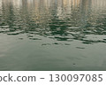 Water textures with light and ripples. Moving water in the harbour give beautiful shimmery textures and surfaces for backgrounds with space for copy 130097085