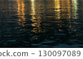 Water textures with light and ripples. Moving water in the harbour give beautiful shimmery textures and surfaces for backgrounds with space for copy 130097089