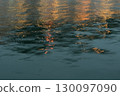 Water textures with light and ripples. Moving water in the harbour give beautiful shimmery textures and surfaces for backgrounds with space for copy 130097090