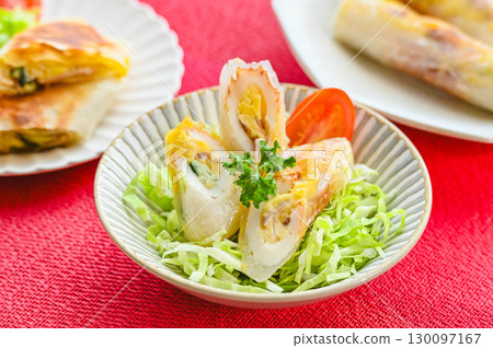 Potato salad and chikuwa spring rolls 130097167