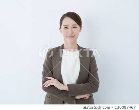 Smiling business woman standing 130097467