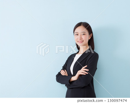Smiling business woman standing 130097474