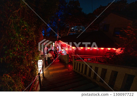 Fujisawa cityscape in Japan: Enoshima at night. Bustling with tourists Fujisawa cityscape in Japan: Enoshima at night. Bustling with tourists 130097722