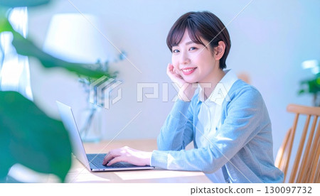 Young woman doing telework in the living room Young woman doing telework in the living room 130097732