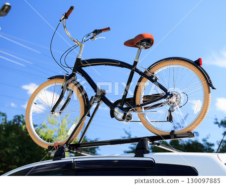Bike transportation - bike on the roof of a car 130097885