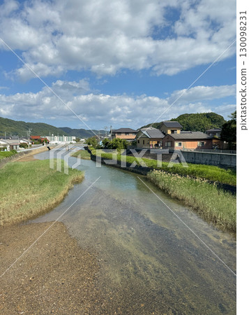 A flowing stream and a residential area A flowing stream and a residential area 130098231