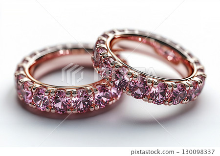 Luxurious pair of wedding rings with pink stones on a white background. Rococo-Renaissance style. Luxurious pair of wedding rings with pink stones on a white background. Rococo-Renaissance style. 130098337