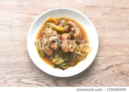 boiled braised salty pork leg and slice pickled cabbage in Chinese herb brown soup on plate 130098446