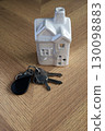 Keys and house on a wooden background 130098883