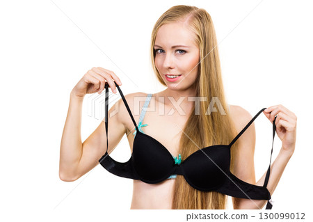 Woman trying on black bra 130099012