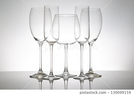 A minimalist display of five empty wine glasses with slender stems A minimalist display of five empty wine glasses with slender stems 130099159