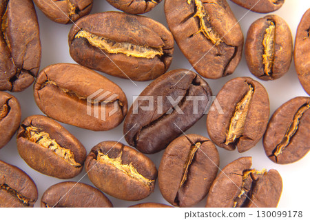 Vibrant macro image of roasted coffee beans, revealing their intricate textures 130099178