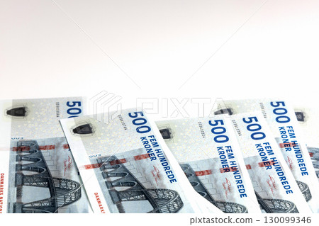 500 kroner notes scattered over white background 130099346
