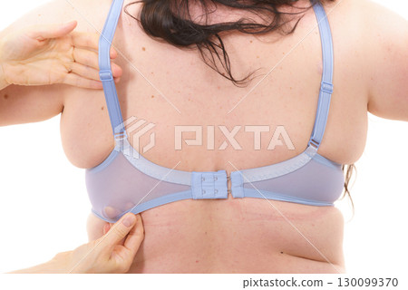 Bra fitter help plus size woman find perfect fit. Back view. 130099370