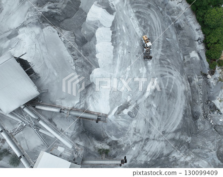 Aerial view of granite and limestone crushing plant with excavators processing raw stone into construction aggregates for concrete and infrastructure development. Stone mill factory. 130099409