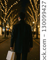 Back view of a man walking through illuminations 130099427