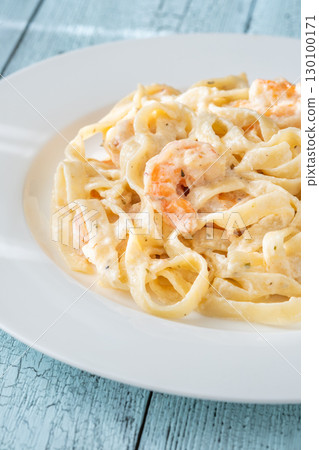 Creamy fettuccine shrimp pasta white plate savory sauce gourmet flavor 130100171