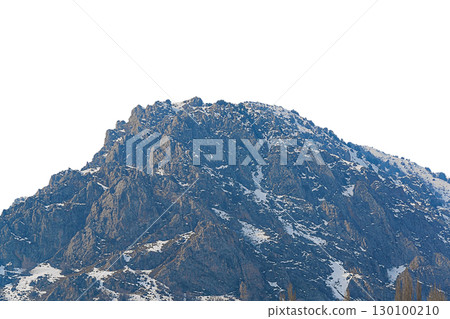 Top of hill of rocky mountain is isolated on white background, slopes cut by sharply protruding stone cliffs, snow cover lies unevenly in different places. Blank for artwork with clipped path Top of hill of rocky mountain is isolated on white background, slopes cut by sharply protruding stone cliffs, snow cover lies unevenly in different places. Blank for artwork with clipped path 130100210