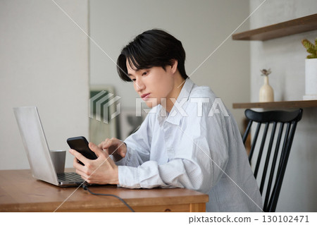 Young Asian man working from home 130102471