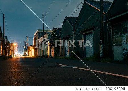 Warehouse district at night illuminated by streetlights 130102696