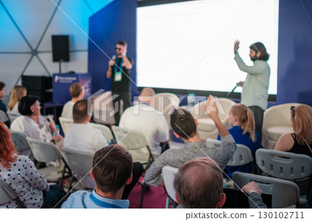 People attending interactive seminar with engaged audience participation 130102711