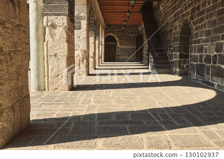 Stone corridor with arches and deep shadows Stone corridor with arches and deep shadows 130102937