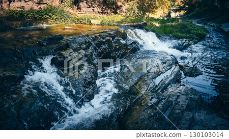 Small Waterfall Flowing Over Flat Rocks in Forest Stream 130103014