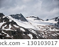 Snow-covered Alpine Peaks under Dramatic Sky 130103017