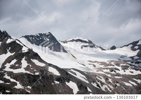 Snow-covered Alpine Peaks under Dramatic Sky 130103017