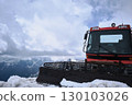 Red Snow Groomer on Snowy Mountain Ridge under Cloudy Sky 130103026