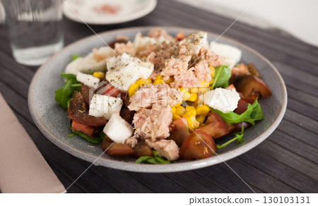 Plate of salad with tuna, corn, tomatoes and arugula Plate of salad with tuna, corn, tomatoes and arugula 130103131