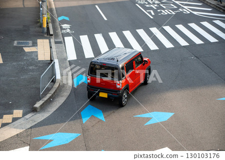 A light vehicle turning left at an intersection and approaching a crosswalk A light vehicle turning left at an intersection and approaching a crosswalk 130103176
