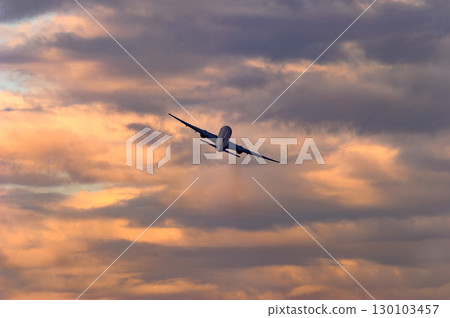 An aircraft flying against a beautiful sky and clouds 130103457