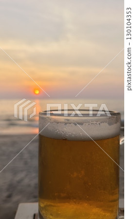 glass of beer on the beach 130104353