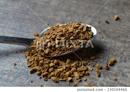 Instant coffee granules on a spoon. close up view Instant coffee granules on a spoon. close up view 130104468