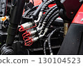 Close-up of hydraulic hoses and connectors on machinery equipment. 130104523