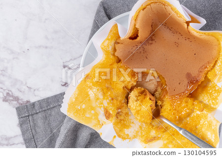 Portuguese sponge cake wrapped in the typical paper used on the baking, on marble background. 130104595