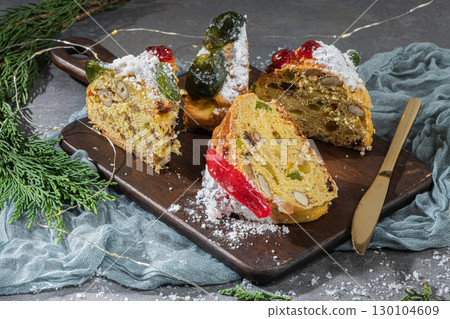 Bolo Rei or King's Cake is a traditional Xmas cake with fruits raisins nut and icing  on kitcthen countertop. Is made for Christmas, Carnavale or Mardi Gras 130104609