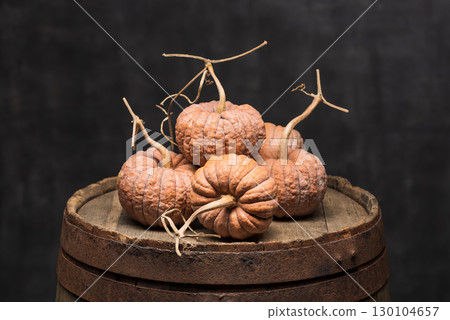Black Futsu Pumpkin Winter Squash on Wooden Barrel 130104657