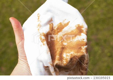 Woman showing large foundation stain on white t-shirt 130105015