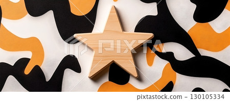 A wooden star shaped object resting on a minimalist abstract geometric pattern background in contrasting black white and orange colors 130105334
