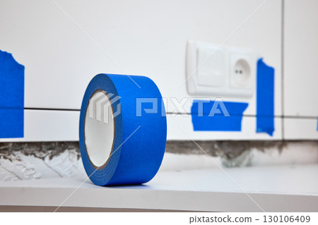 masking tape on countertops, blue masking tape for tiling kitchen walls, copy space 130106409