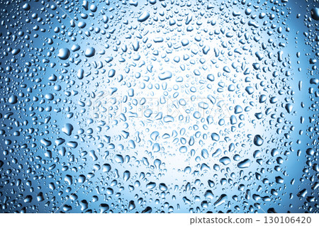 Water drops on glass on a blue background. 130106420