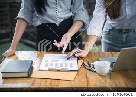Business team meeting and discussing project plan. Businesswomen discussing together in cafe co-working space. Professional investor working with business project together. Finance managers task. 130106561