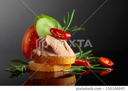 Bread slices with pate, tomato, cucumber, red pepper, and rosemary. 130106845