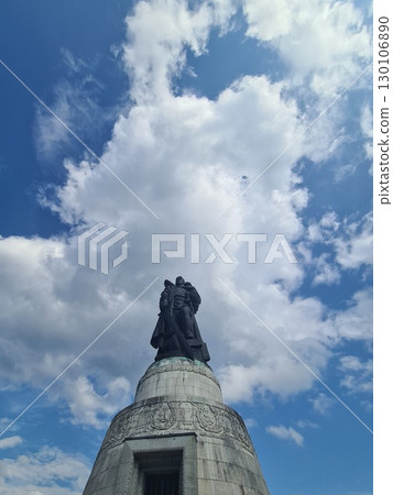 Berlin, Germany - August 1, 2025: Soviet War Memorial, Treptower Park, bronze statue of a Soviet soldier with a sword holding a German child, standing over a broken swastika Berlin, Germany - August 1, 2025: Soviet War Memorial, Treptower Park, bronze statue of a Soviet soldier with a sword holding a German child, standing over a broken swastika 130106890