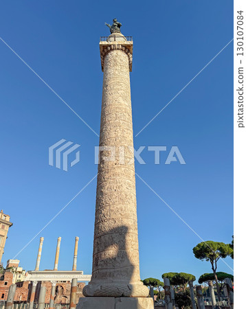 Trajan's Column that commemorates Roman emperor victory in the Dacian Wars, located in Trajan's Forum with ancient ruins and classical architecture surrounding it in Rome, Italy Trajan's Column that commemorates Roman emperor victory in the Dacian Wars, located in Trajan's Forum with ancient ruins and classical architecture surrounding it in Rome, Italy 130107084