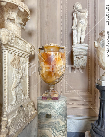Ancient Roman artifacts and sculptures collection with a large onyx urn on a fluted marble pedestal inside the Pio-Clementino Museum in Vatican Ancient Roman artifacts and sculptures collection with a large onyx urn on a fluted marble pedestal inside the Pio-Clementino Museum in Vatican 130107101
